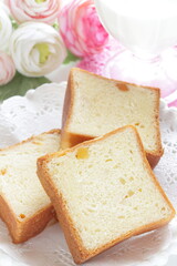 Sliced orange bread on wooden board with copy space