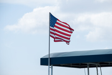 American flag waving in the air at Hawaii pear harbor Arizona memorial on the fourth of July 
