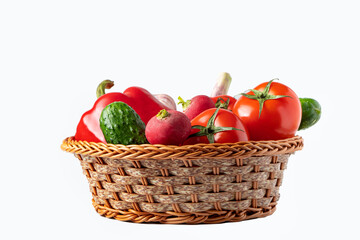 Assorted fresh vegetables in a basket on a white background. Eco food concept.