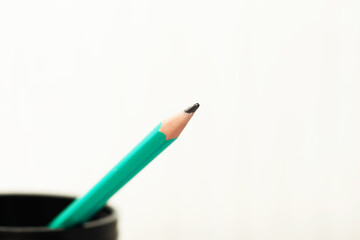 Green pencil on a white background.