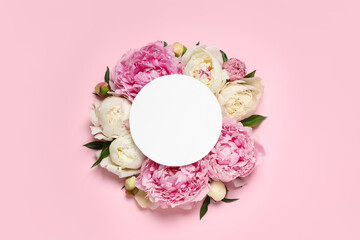 Beautiful peonies and blank card on pink background, flat lay. Space for text