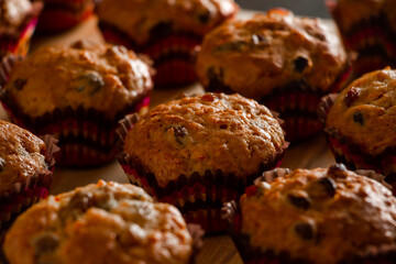 Homemade muffins on a wooden cutting board. Traditional festive Christmas baking.