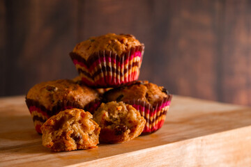Homemade muffins on a wooden cutting board. Traditional festive Christmas baking.