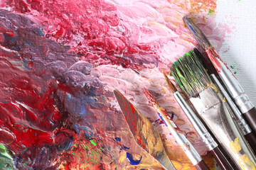 Fototapeta premium Abstract colorful artwork and brushes, closeup view