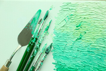 Abstract colorful artwork and brushes, top view
