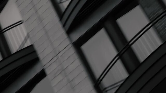 MONTREAL, CANADA - MARCH 14 2019 Sepia toned dutch angle shot of modern apartment complex. Patios of the second floor apartments pass by the screen..