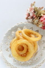 Fast food, onion rings on dish for unhealthy food