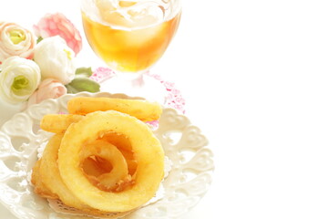 Fast food, onion rings on dish for unhealthy food