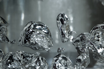 Drops and bubbles of mercury in water. Dangerous chemical element, the scientific experience.