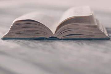 old paper book, open on wooden desk