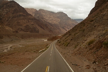 Traveling along the asphalt road in the mountains and desert on the way to mount Aconcagua. 