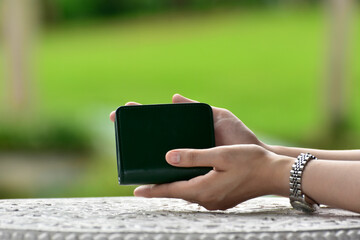 
An elegant wallet in a woman's hand
Green bag
For inserting money