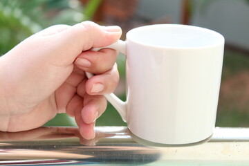 Hands holding a mug