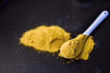 heap of curcuma powder isolated on Black background