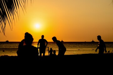 Amateurs playing football at Jumeira beach in Santa Marta, Colombia during sunset.