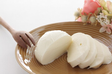 Sliced Mozzarella cheese and on dish 