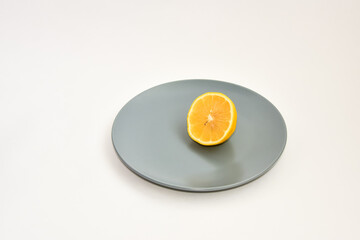 sliced lemon on a plate on a white background