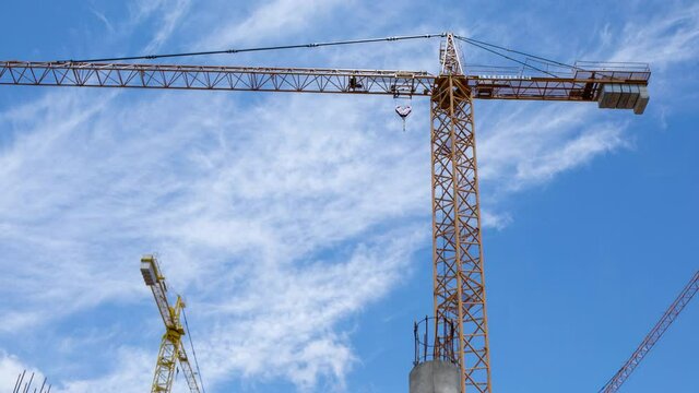 Timelapse footage of clouds in sky with construction crane