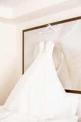 Wedding gown dress hanging on holder in the room before outdoor wedding of tropical caribbean destination marriage matrimonial ceremony 