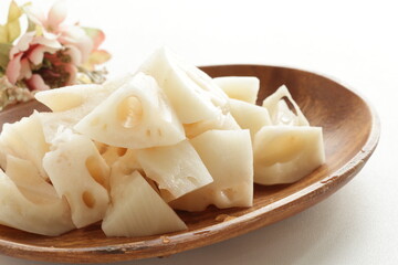 Chopped lotus root on wooden plate for prepared food ingredient