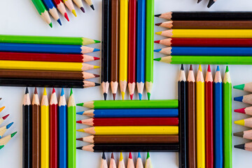 Colorful crayons,pencils designed group of five on the white surface,top view.