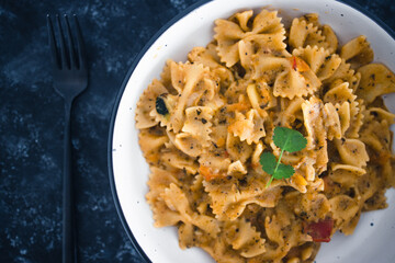 plant-based food, vegan garlic tahini sauce pasta with mediterranean vegetables