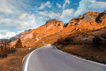 Mountains with alpine village on sunny summer day, the Dolomites Mountains, Italy