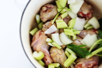 celery and onion with chicken in pot for stew cooking