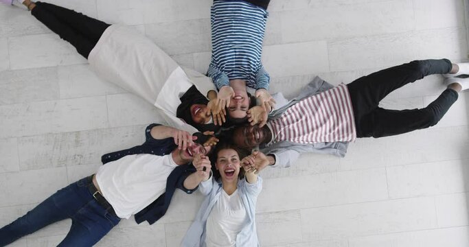 Group of happy young students showing unity