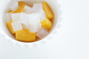 canned peach and Nata de coco in bowl for healthy dessert