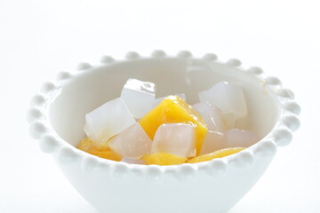 canned peach and Nata de coco in bowl for healthy dessert