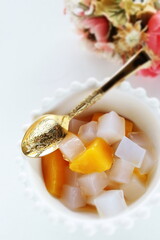 canned peach and Nata de coco in bowl for healthy dessert