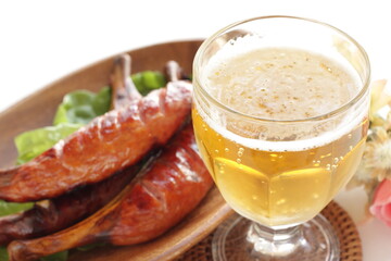 Grilled bone sausage on wooden plate with copy space