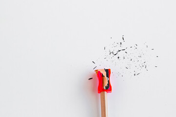 Natural wood pencils with red sharpener on the white surface.Conceptual image of education.