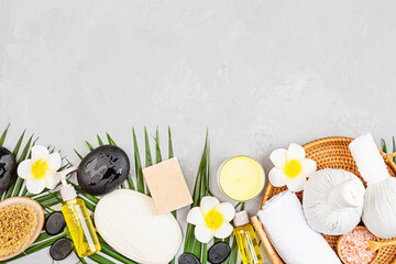Spa massage Aromatherapy body care background. Spa herbal balls, cosmetics, towel and palm leaves...
