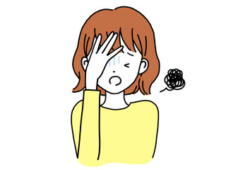 頭を抱え不安な表情をする若い女性