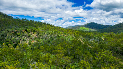 Fototapeta na wymiar Kroombit Tops National Park summer landscape with fresh water creek and swimming hole and vibrant green vegetation, Queensland