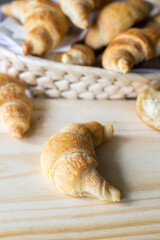 Fresh croissants on the table and in a wicker basket for Breakfast