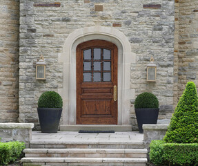 Fototapeta na wymiar Elegant wooden front door of stone faced house