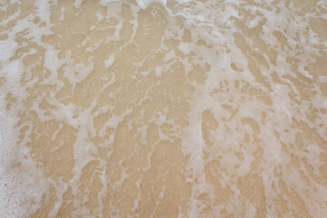 Clear foamy water on the beach