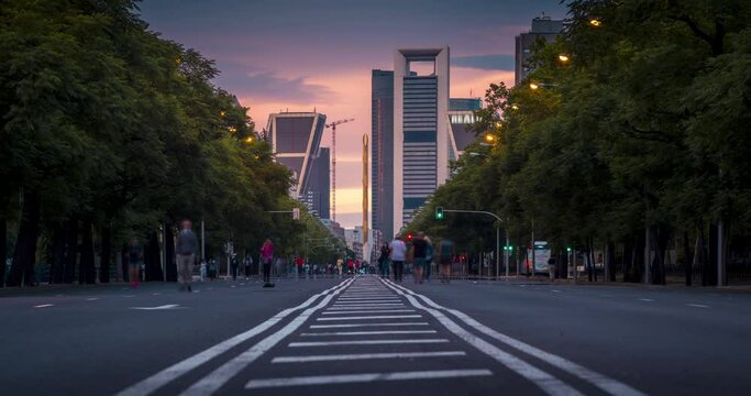 Day to night Time lapse of Paseo de la Castellana in Madrid, Spain. People walking on the street covid 19. People leave the street and cars start to circulate.