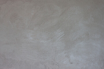 Textured of plastered cement wall is uneven and still wet for background.