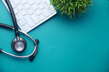 Medical Stethoscope and keyboard on color background 