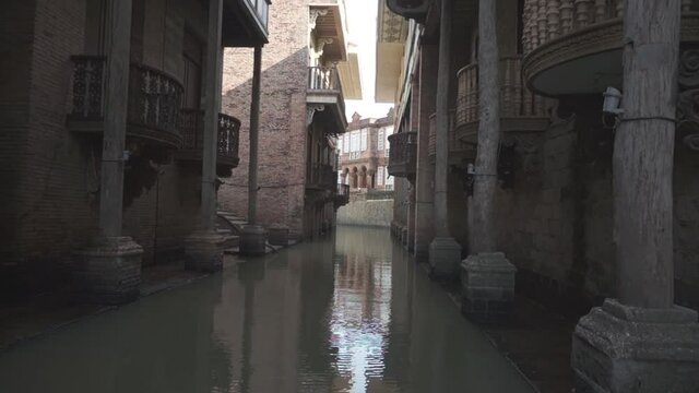 View of a river in the middle of two huge architecture building, Las Casas Filipinas de Acuzar, Bataan,Philippines, 60fps