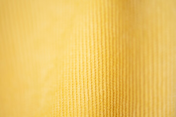 Textured fabric background of Yellow corduroy.