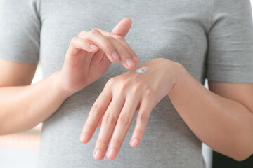 Closeup of hands applying moisturizer. Beauty woman holding care cream of skin cream.