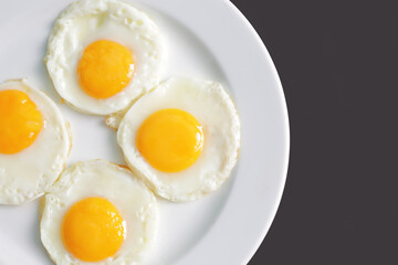 Four fried eggs for healthy breakfast. top view
