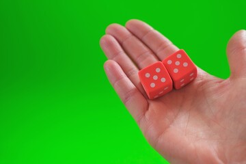 games of chance.gambling game concept. Good luck and luck.Board games.Cubes in a hand on a green...