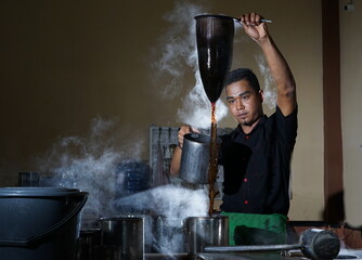 Barista brewing coffee with traditional way at Local Coffee Shop, Aceh Indonesia