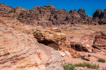 It's Canyon in Petra (Rose City), Jordan. The city of Petra was lost for over 1000 years. Now one of the Seven Wonders of the Word